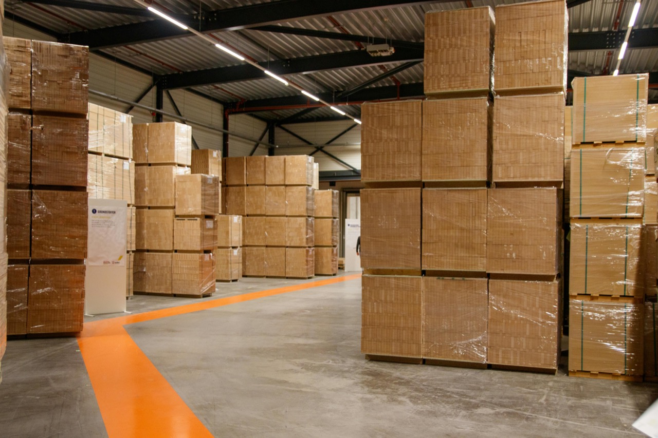 Warehouse loading dock with delivery truck departing.